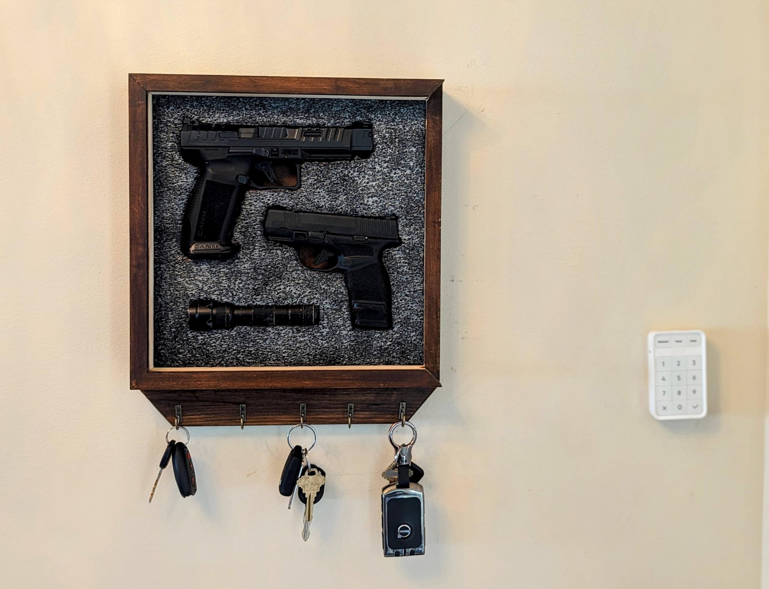 Concealed handgun storage behind a frame