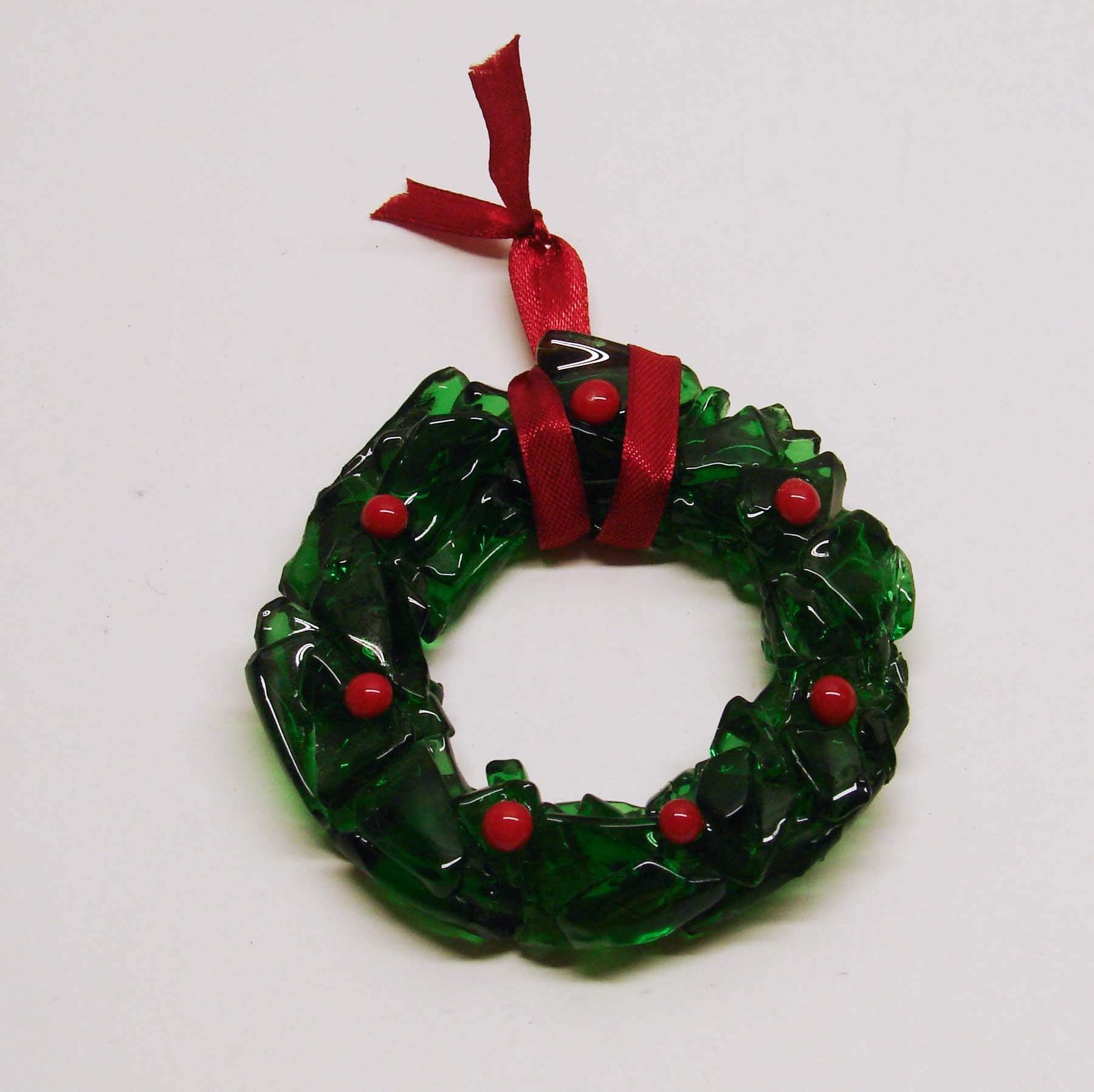 Red glass berries decorate the wreath