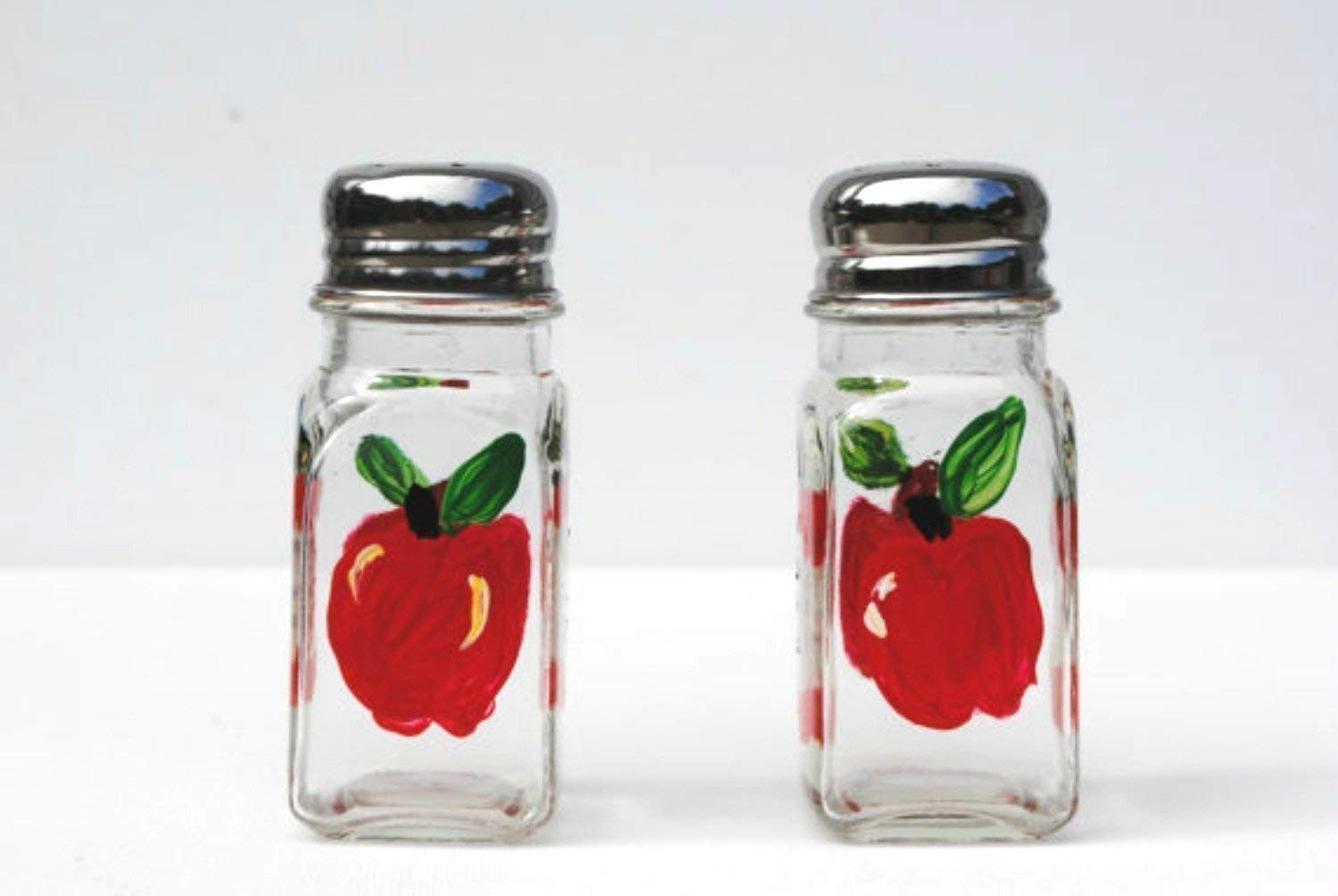 Red Apple glass salt and pepper shakers with silver tops on display