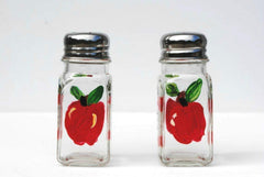 Red Apple glass salt and pepper shakers with silver tops on display