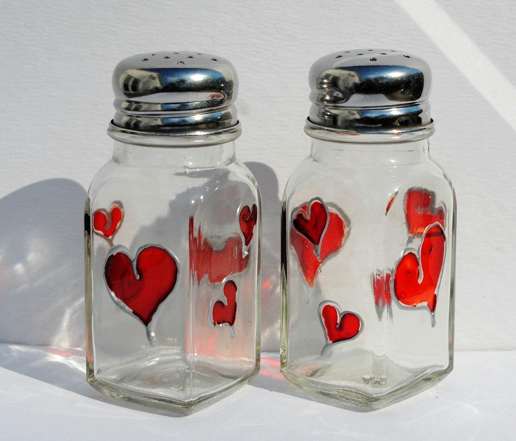 Red Hearts salt pepper shakers on glass