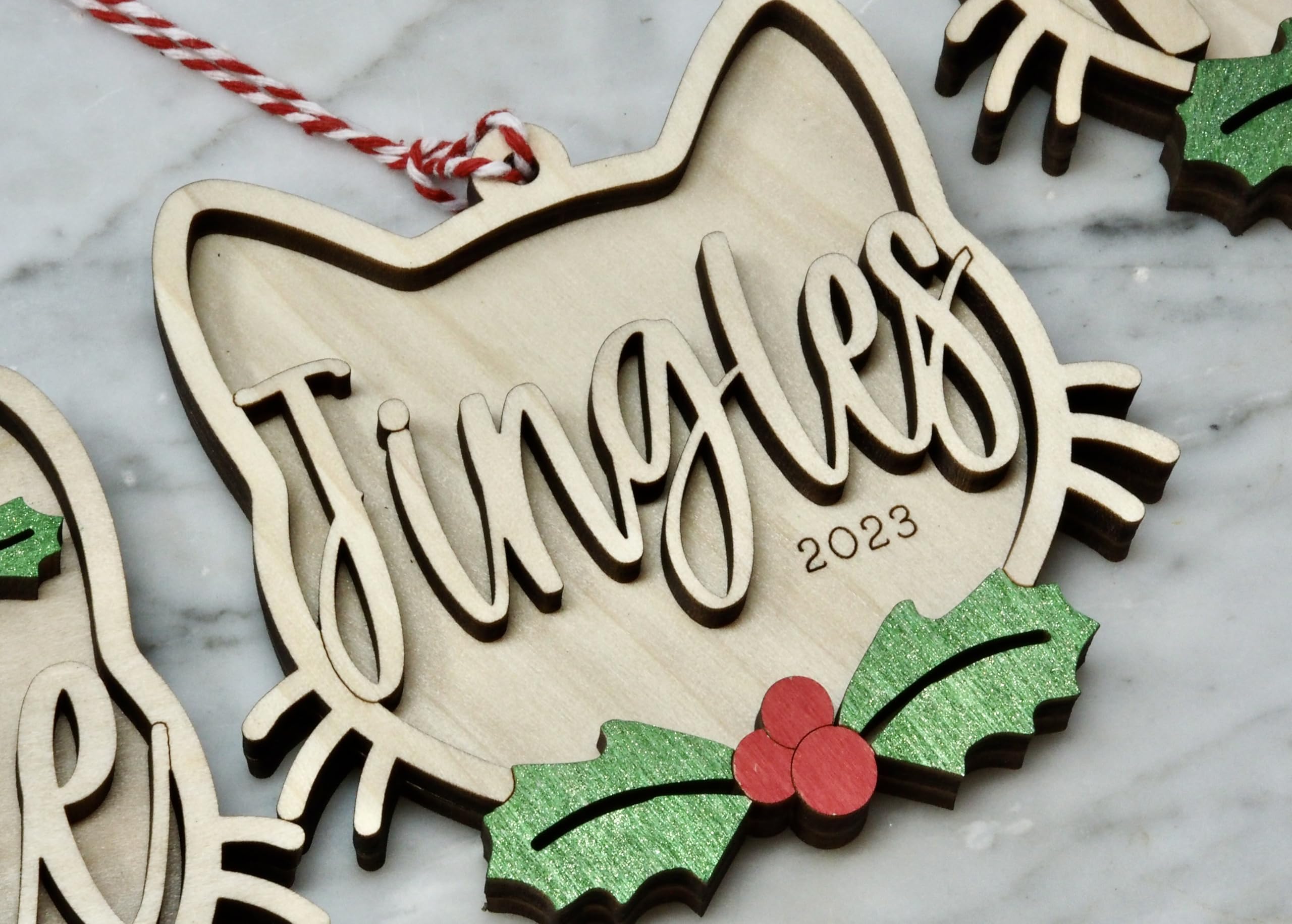Cat Christmas ornament with red and white hanging cord