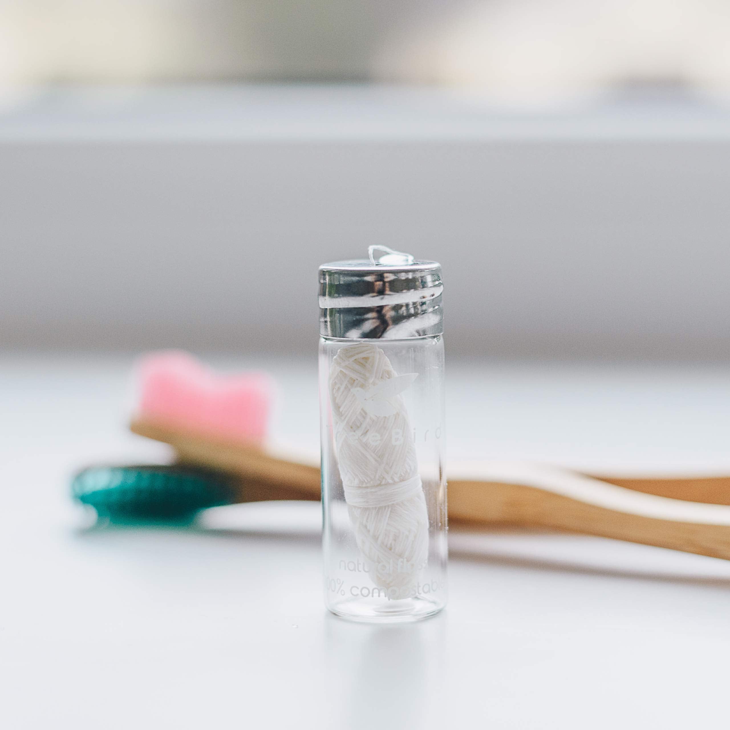 Clear glass dispenser with built-in cutter and metal cap