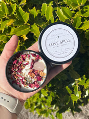 Candle topped with rose petals and lavender buds and Rose Quartz stone