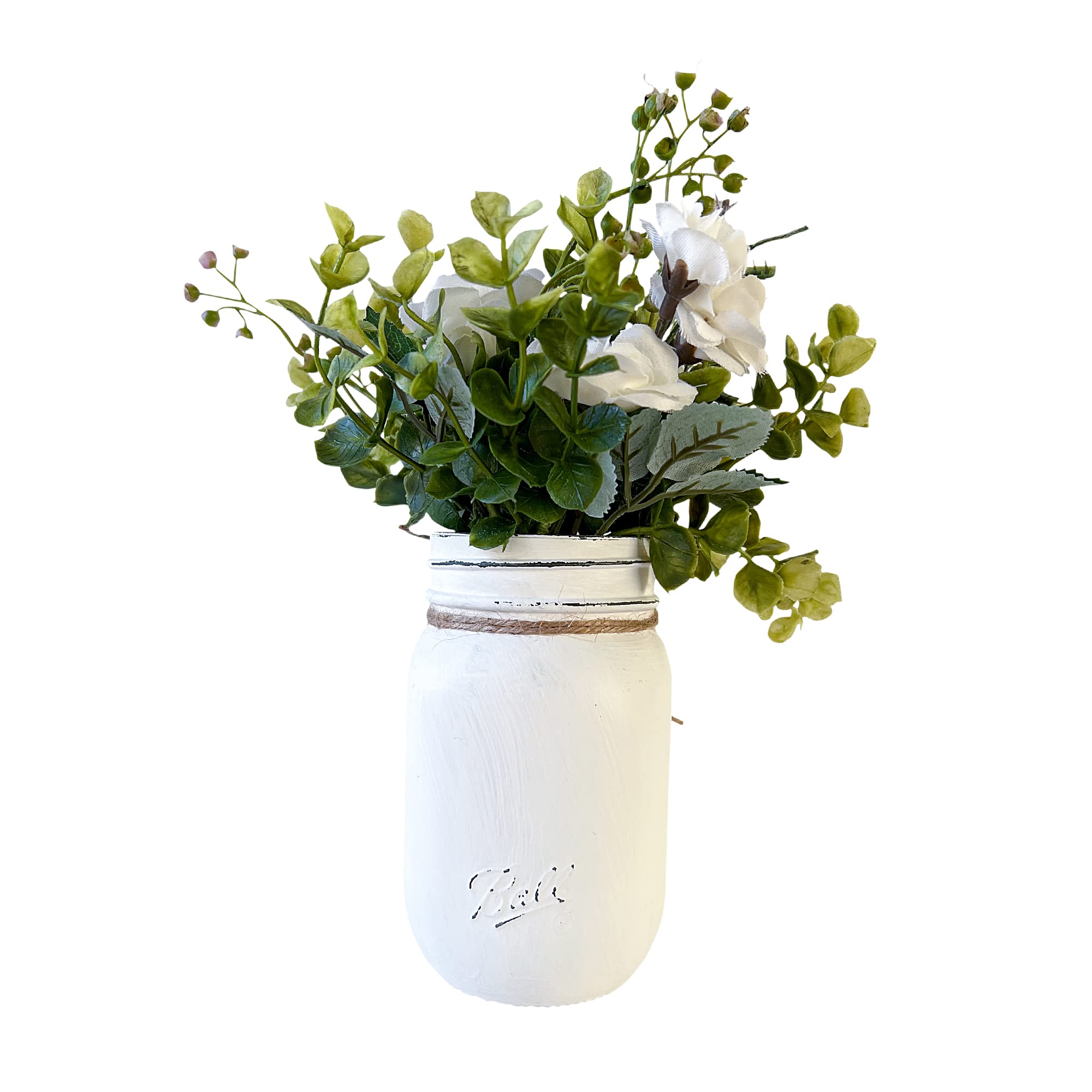 White distressed mason jar with decorative greenery