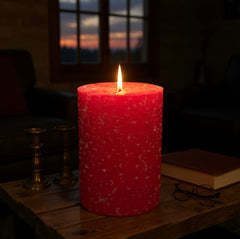 Red pillar candle on Christmas décor with cotton wick
