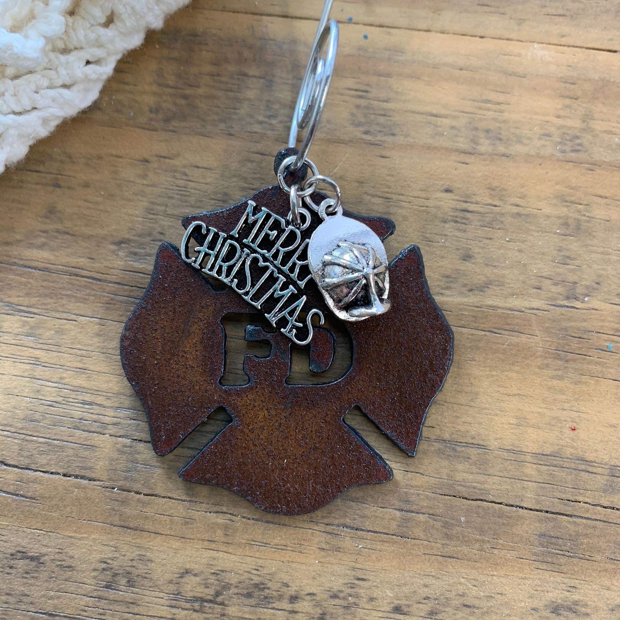 Rustic metal ornament with Merry Christmas and fireman helmet charms