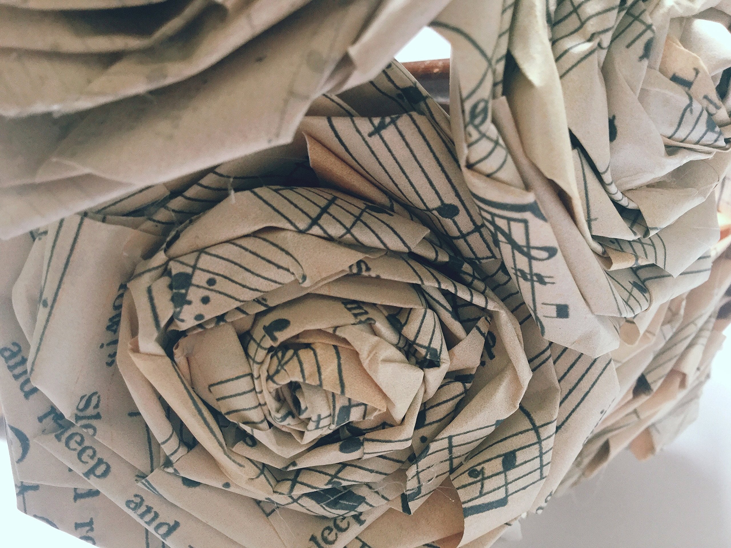 Rustic wooden sticks with paper rose heads about 15 cm long
