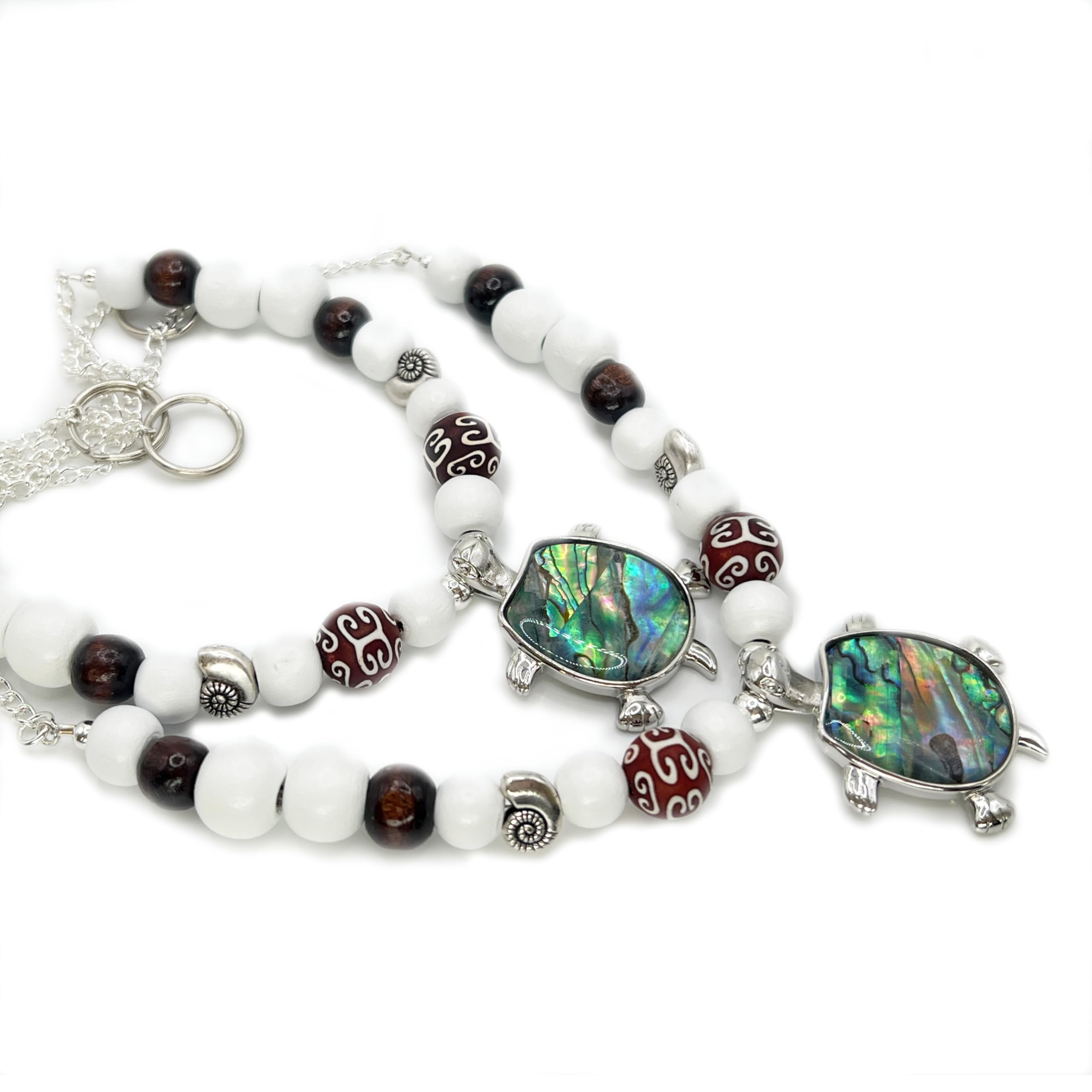 Sea turtle pendant with iridescent abalone shell on white wood bead strand