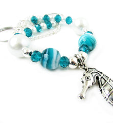 Seahorse tiebacks with metal rings at ends