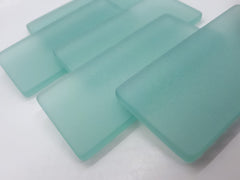 Machine tumbled sea glass with rounded edges and frosted surfaces