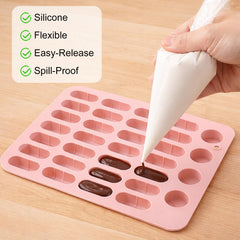 Pink silicone pill mold tray with 28 capsules across 5 sizes