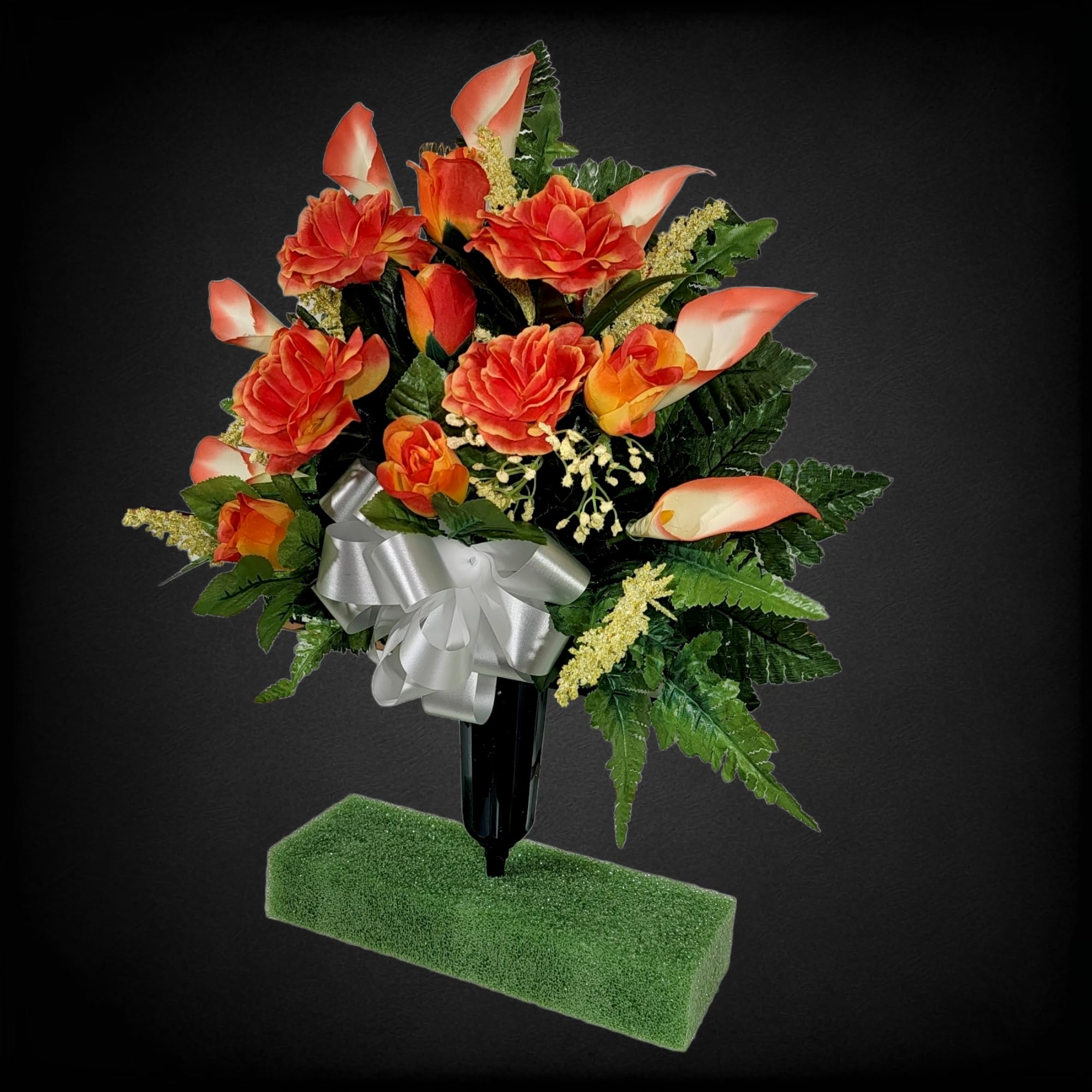 Silk faux grave flowers featuring orange roses and calla lilies