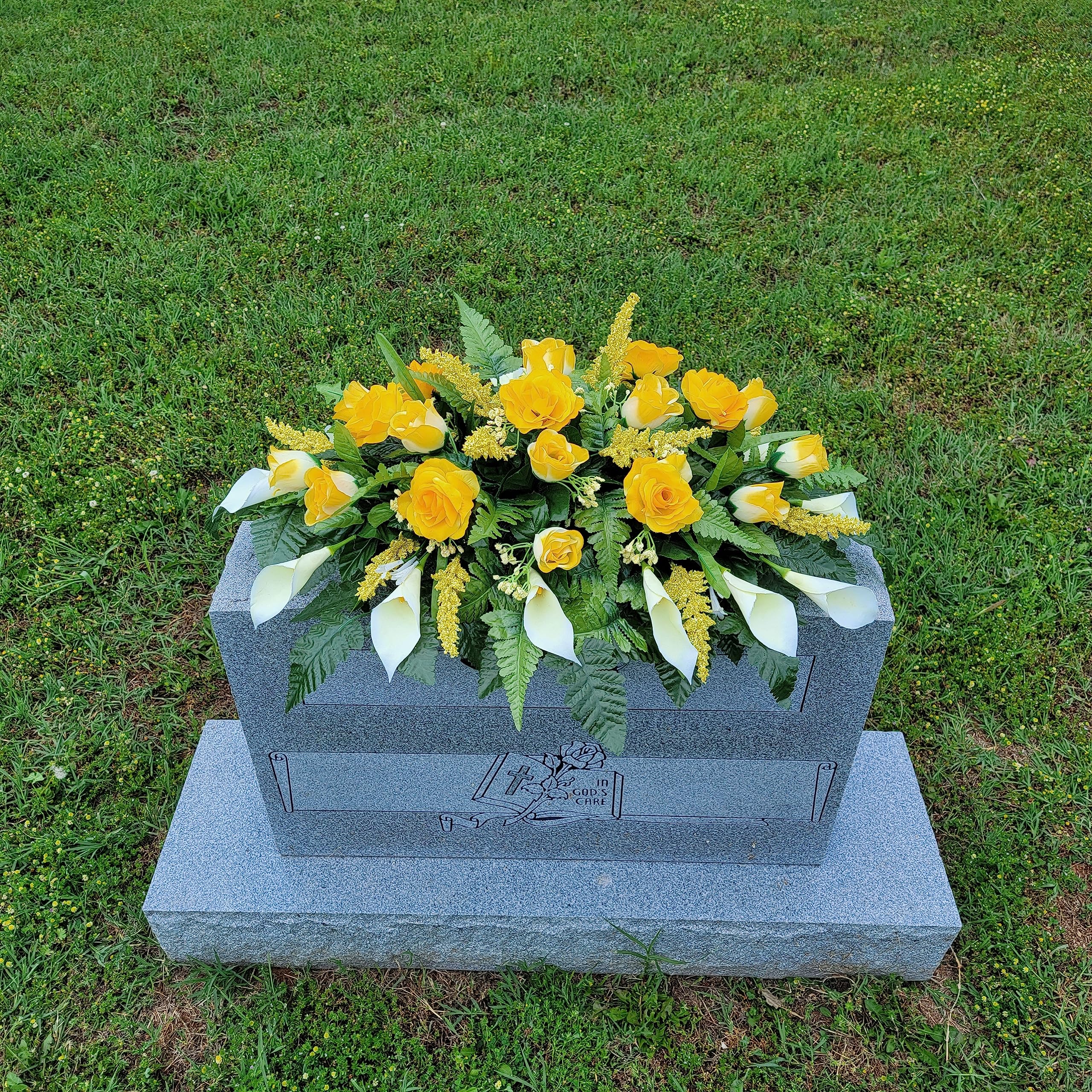 Silk fern with calla lilies on grave marker saddle