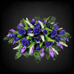 Silk grave flowers roses and calla lilies on saddle