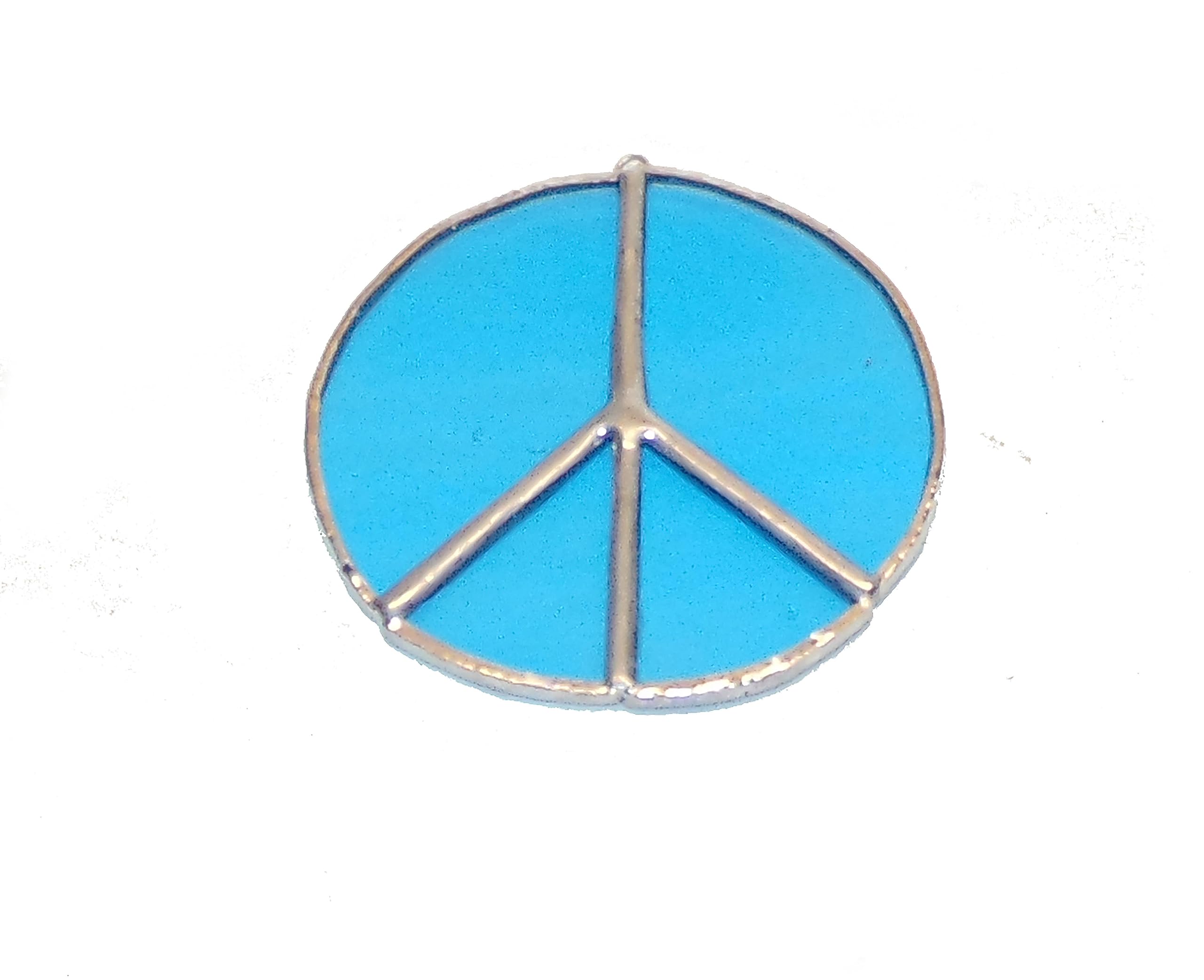 Handmade stained glass peace sign ornament close up