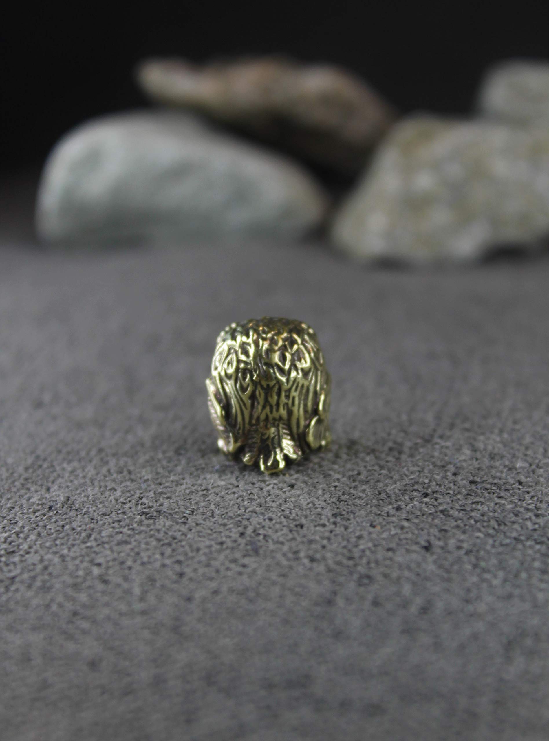 Small brass owl footprint about 1.5 cm by 1.5 cm