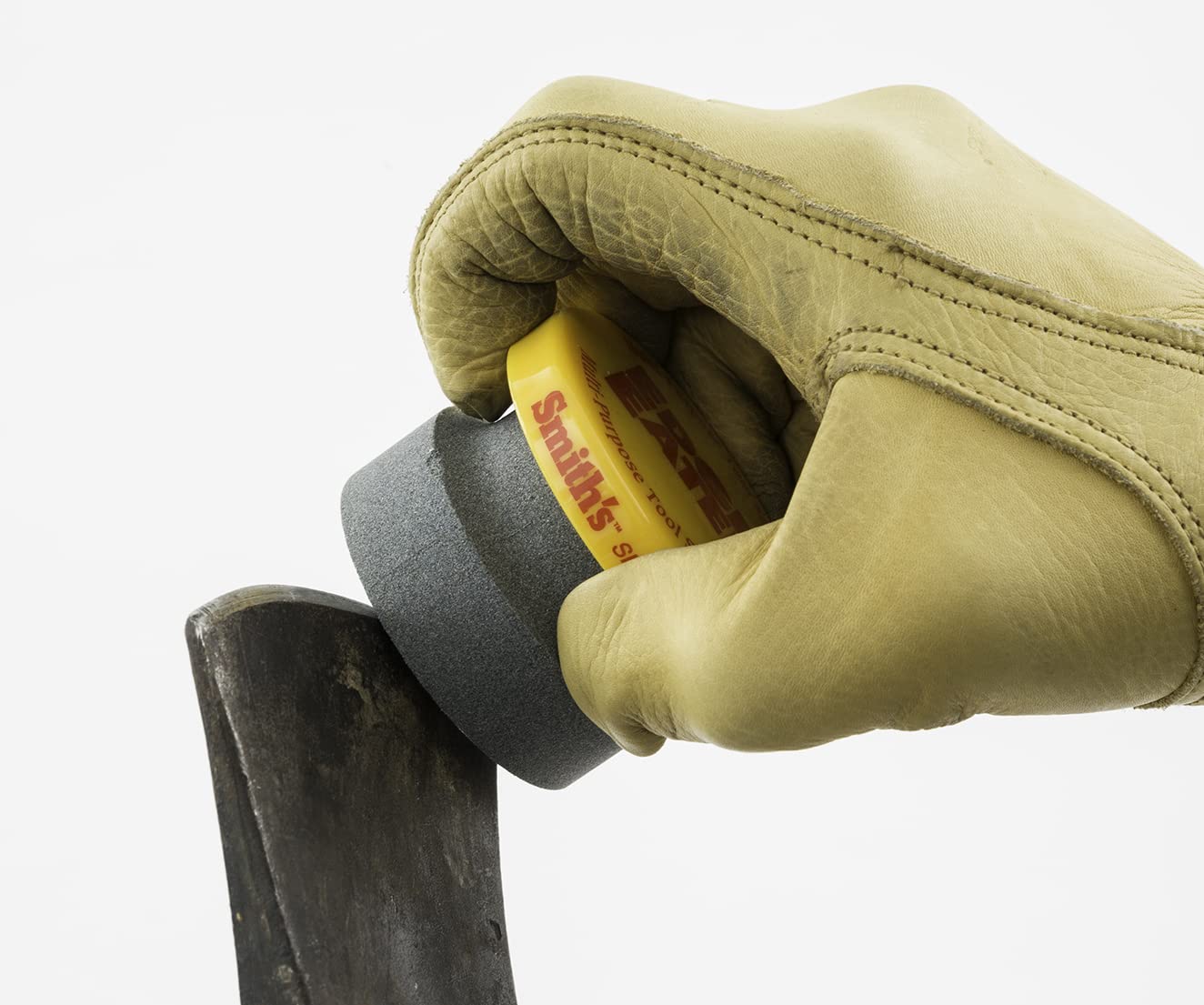 Stone cap protects the hand during use of the sharpener with groove grip