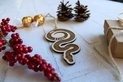 Birch wood ornament measures 4.5 x 2.5 inches