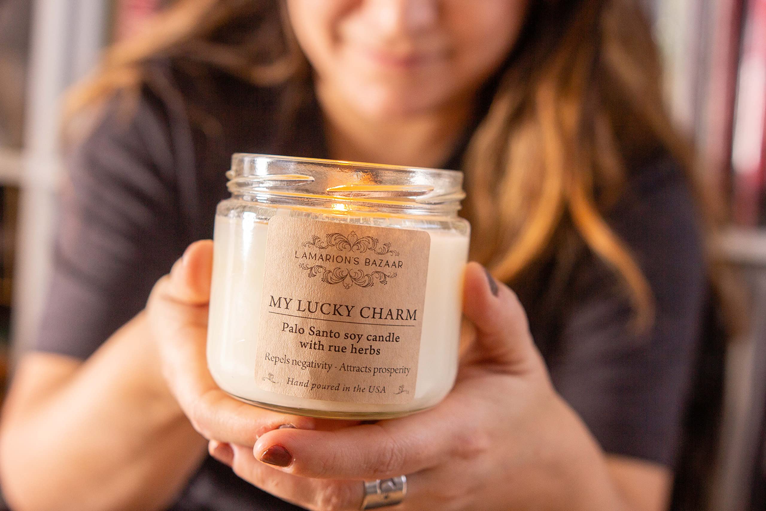 Glass jar candle decorated with Rue herbs inside