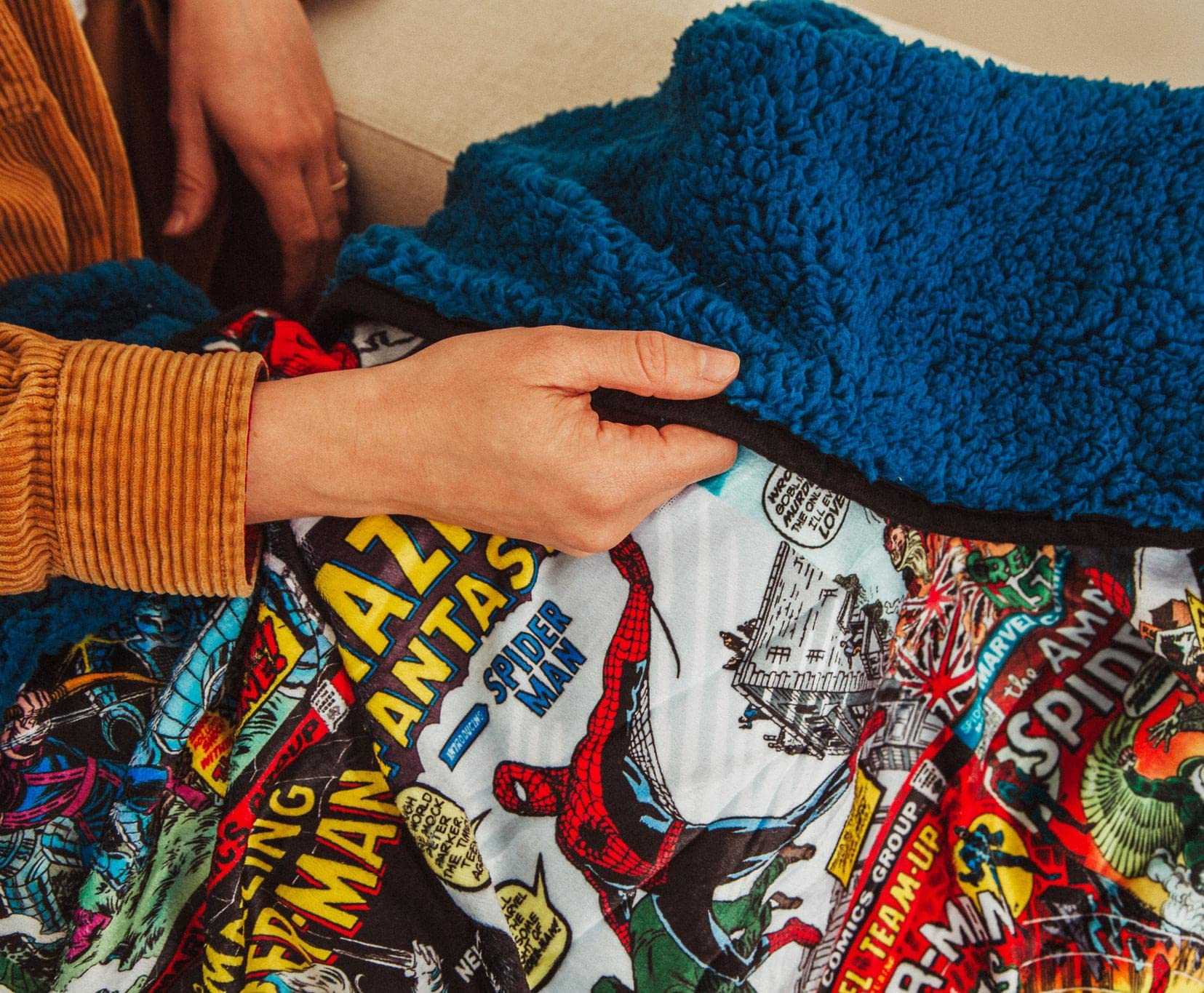 Spider-Man collage featuring classic comic covers on blanket