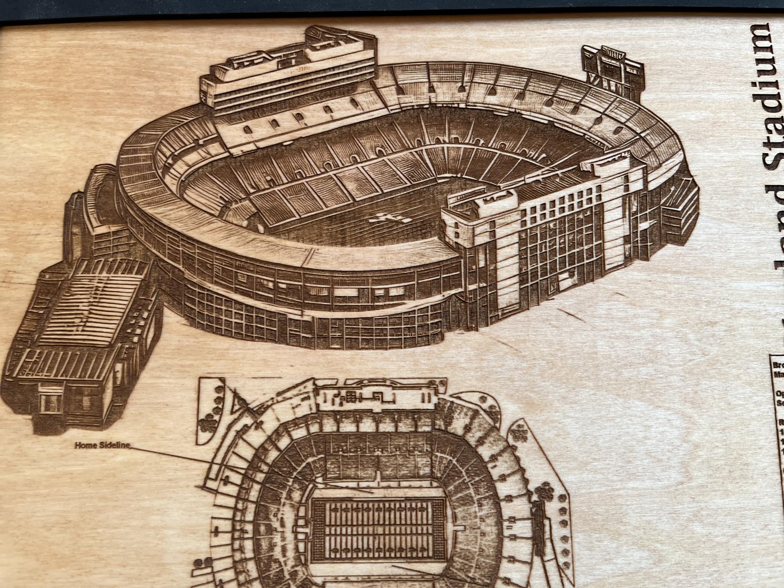 Stadium blueprint and history facts etched on wood decor