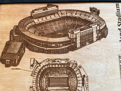 Stadium blueprint and history facts etched on wood decor