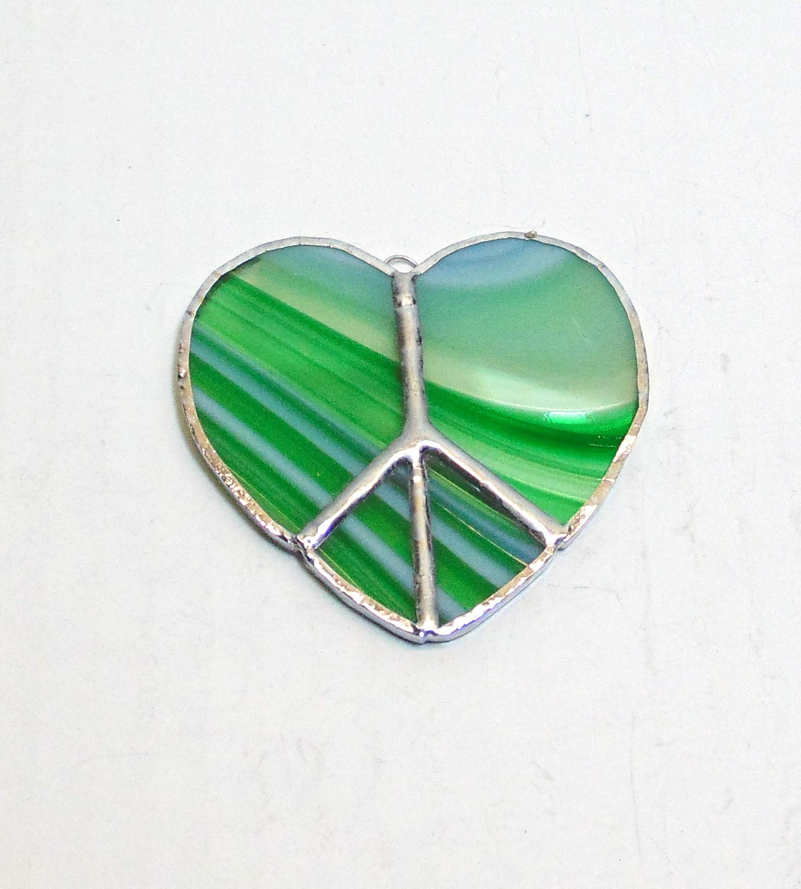 Stained glass ornament with peace sign design