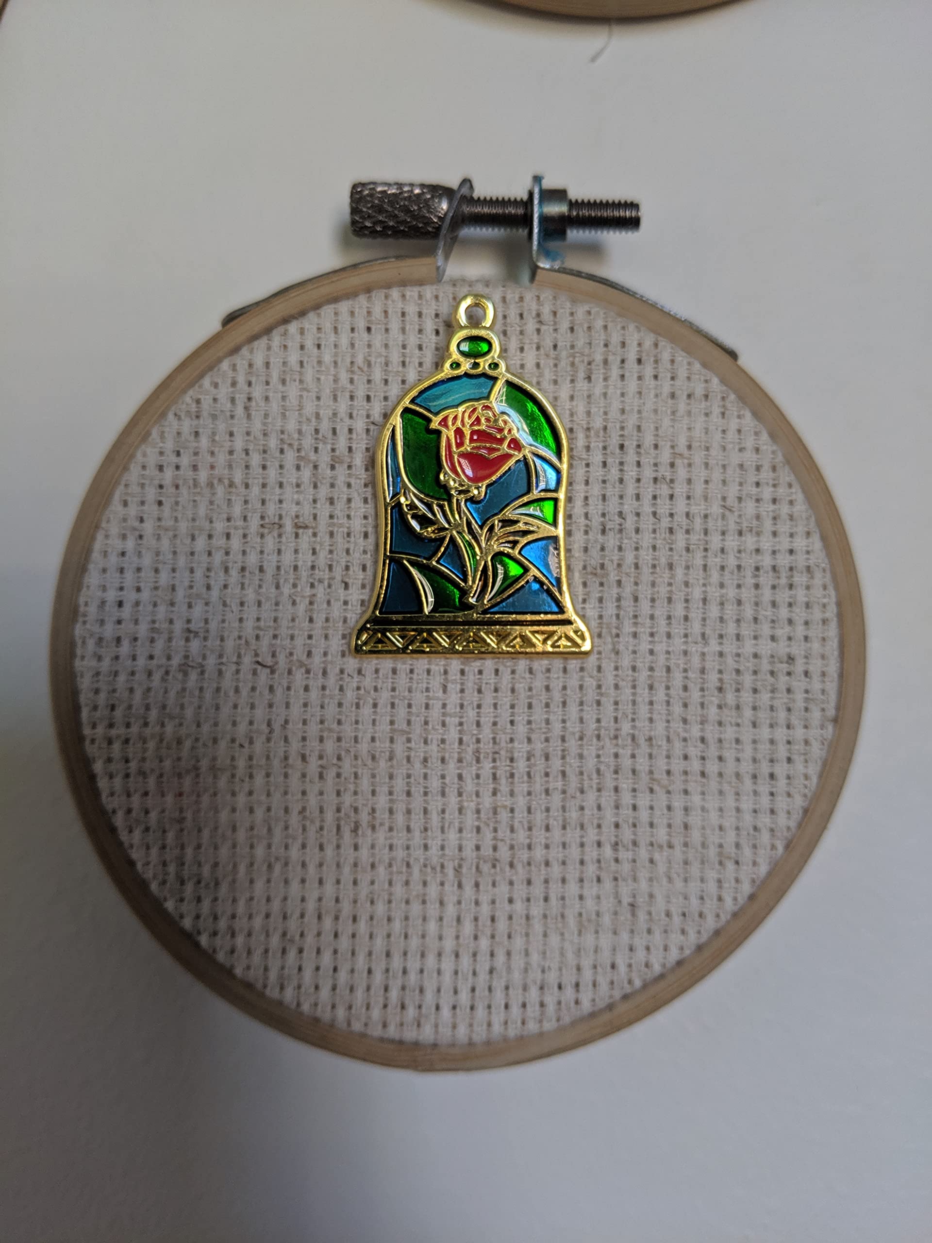 Back magnet on Stained Glass Rose Needle Minder securing to fabric