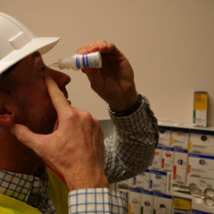 Squeezable eye wash bottle with nozzle for direct application