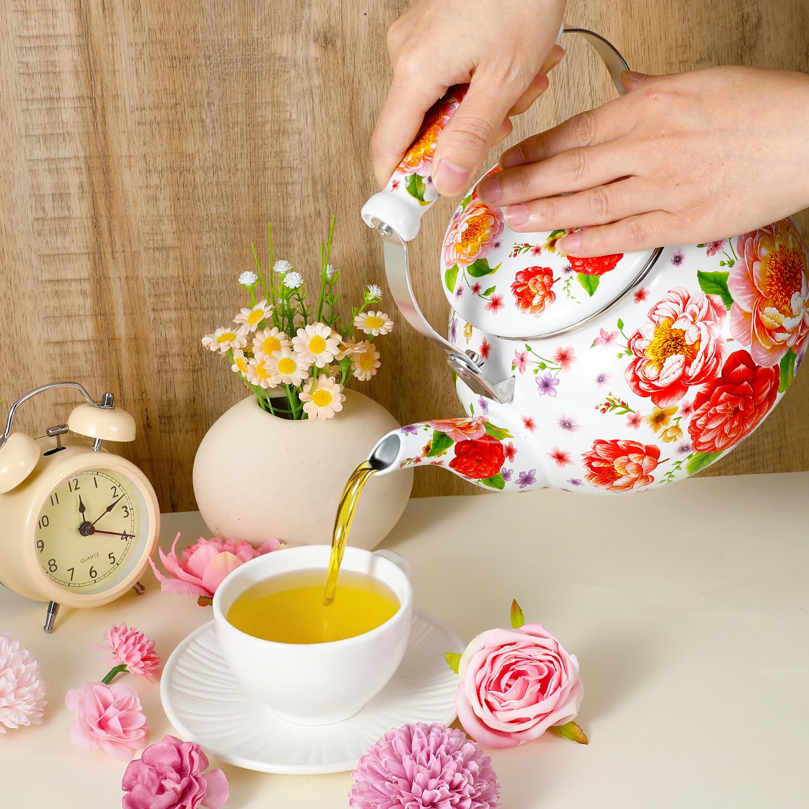 Colorful enamel kettle highlighting garden pattern design