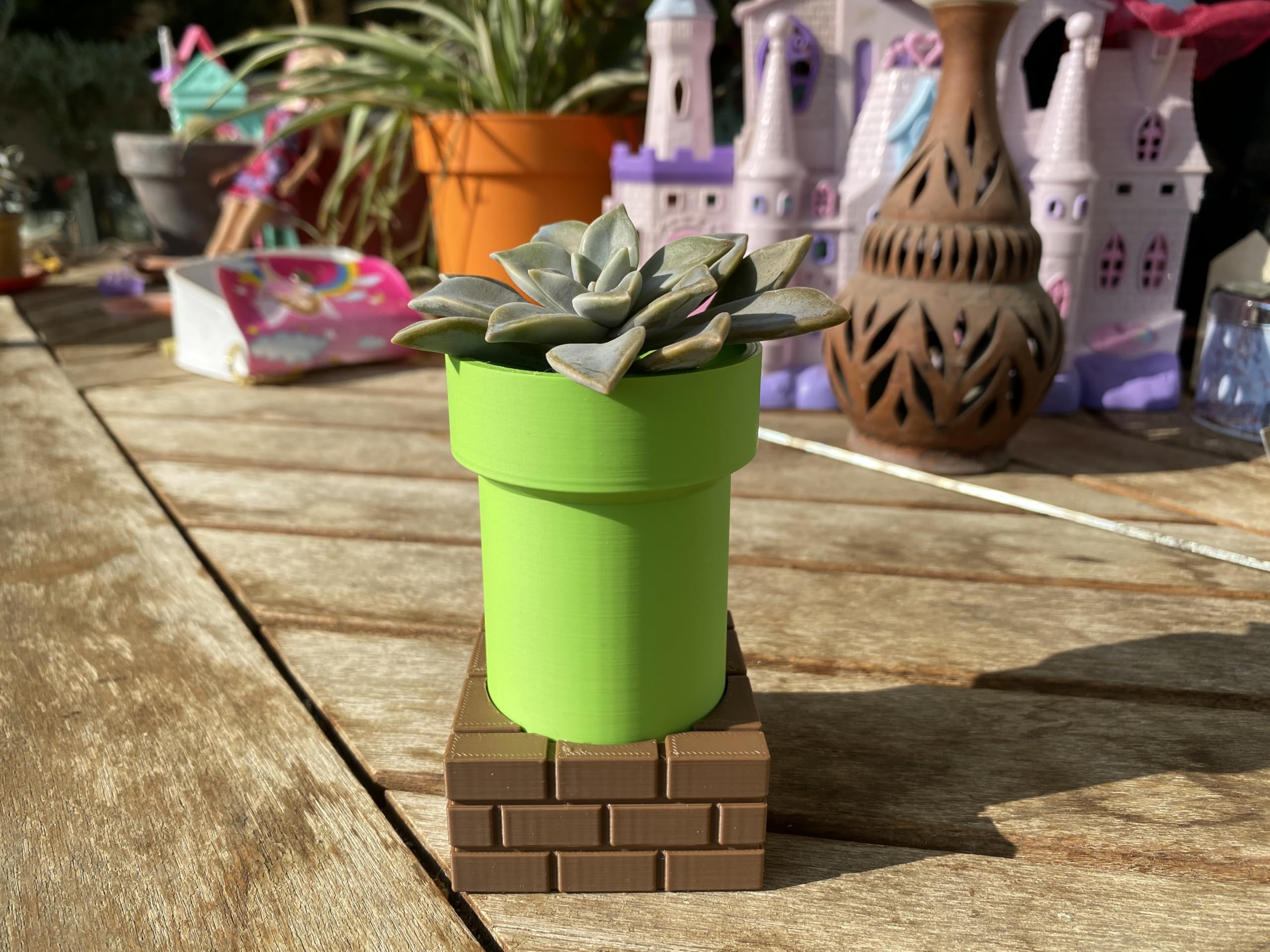 Flower pot variant on desk with small plant