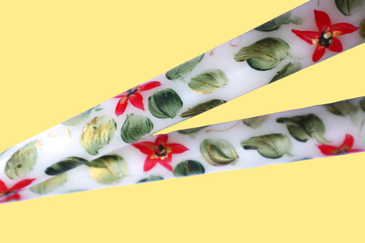 Red poinsettia with golden green centers on a taper candle