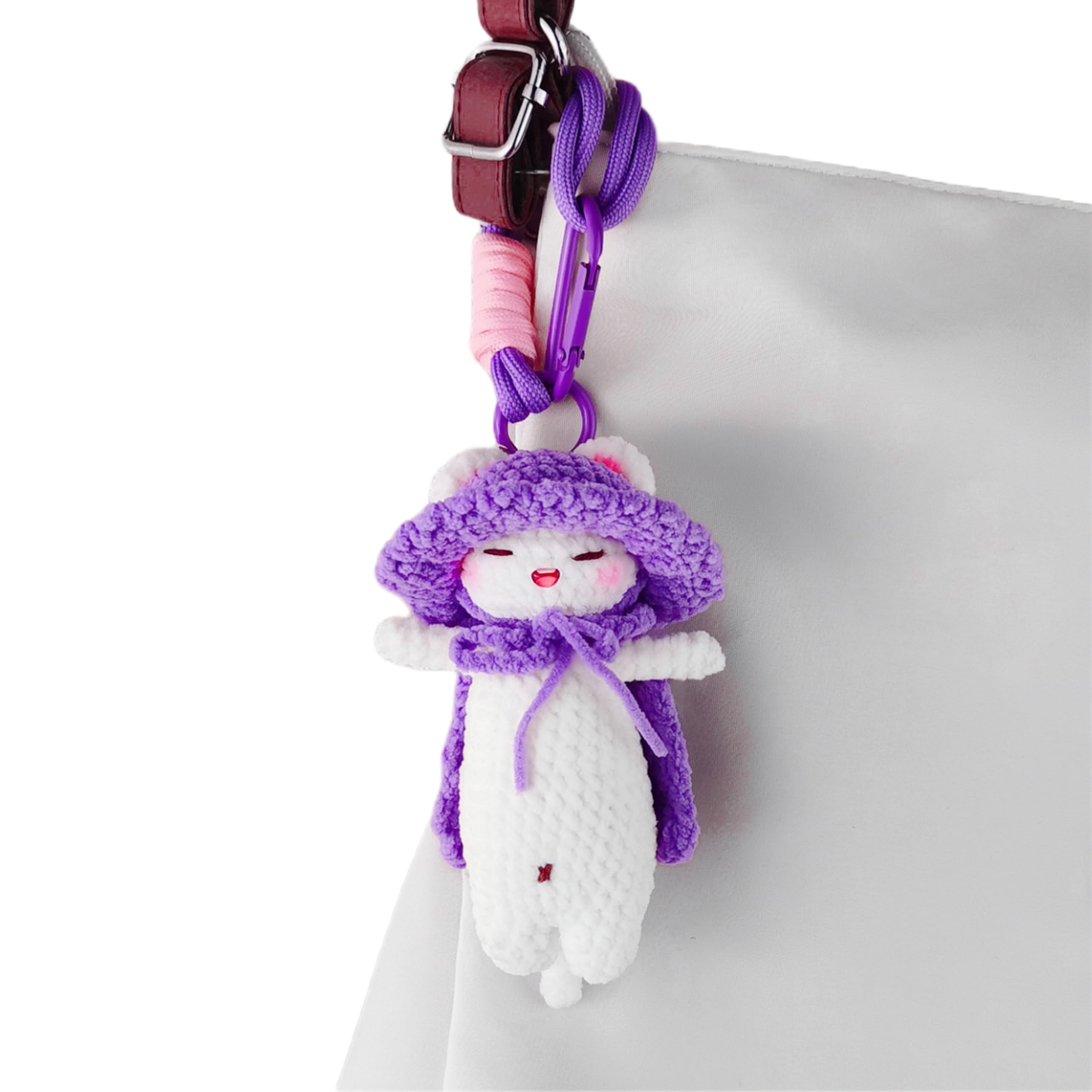 Handmade crochet cat keychain with purple accents and gift box