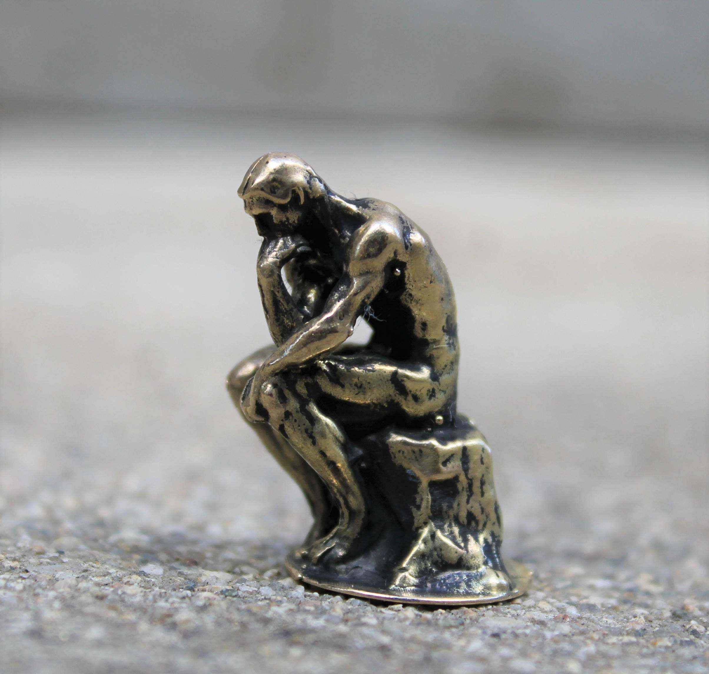 The Thinker by Rodin brass figurine close up
