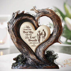 Two intertwined tree branches forming a heart on plaque