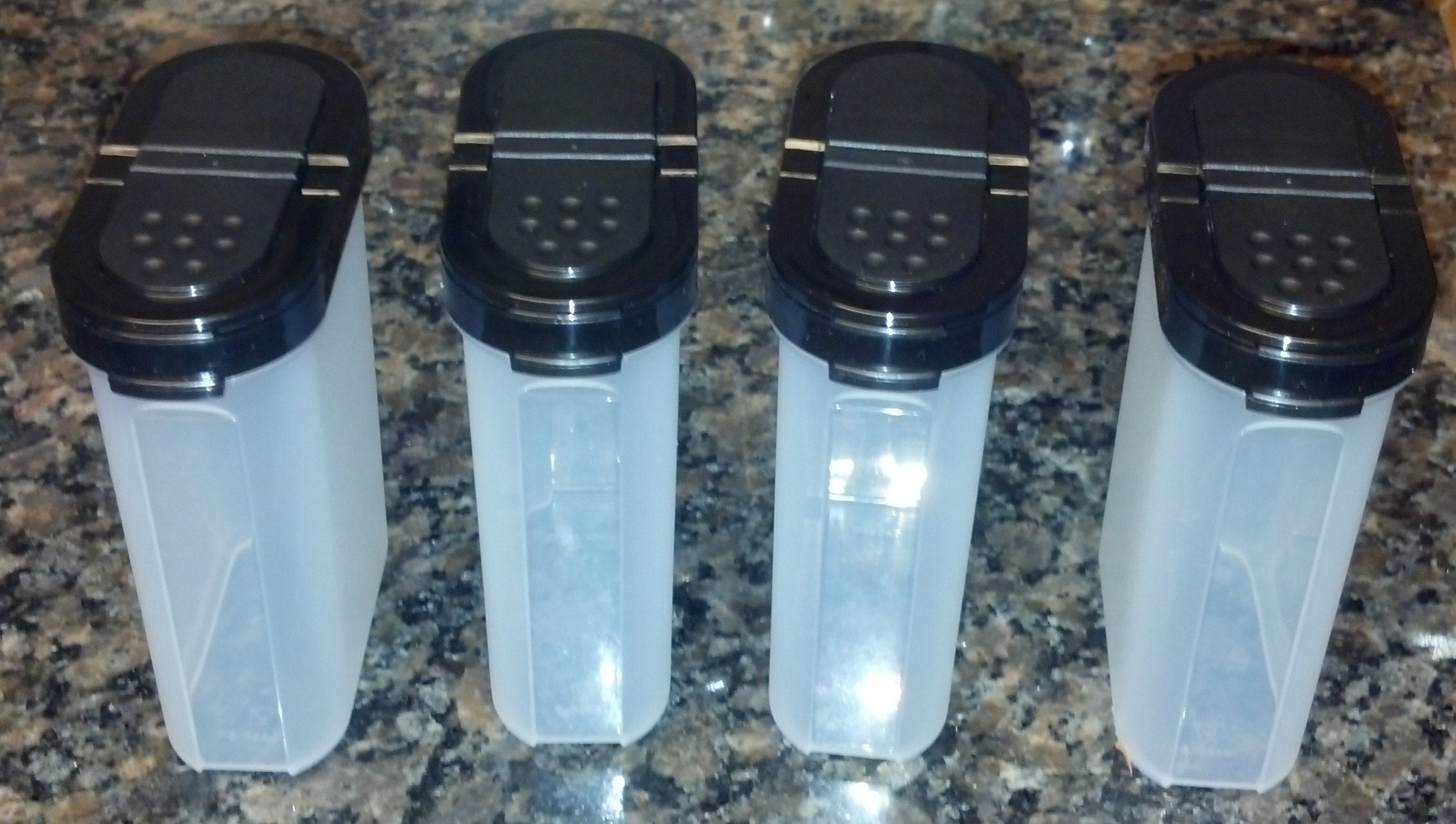 Four 1 cup capacity spice containers with dual sided seals
