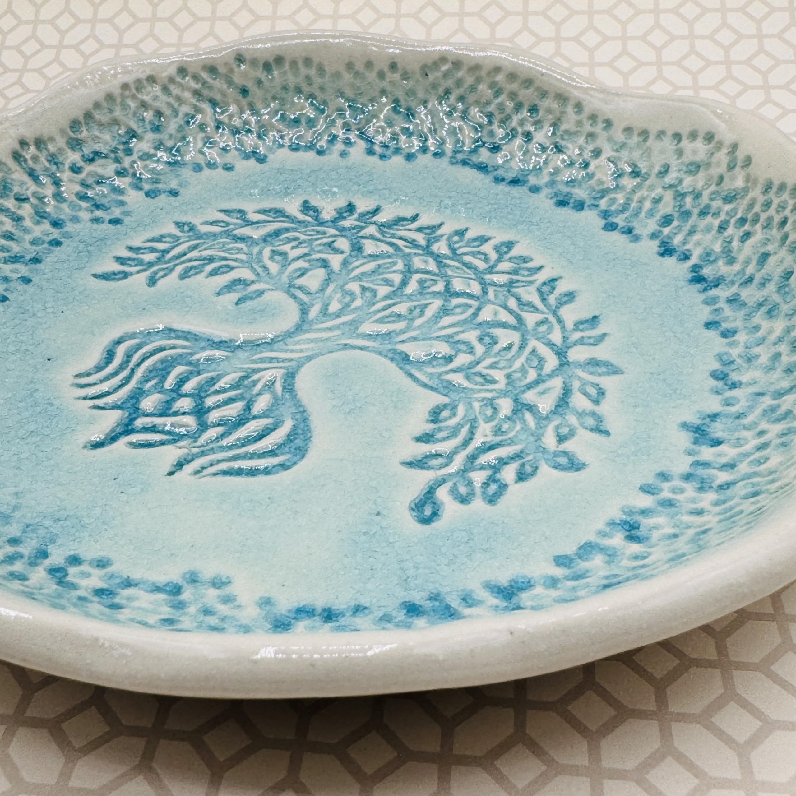 Turquoise glaze detail on round family tree tray
