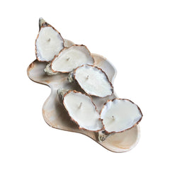 Gold edition oyster shell candle on a natural shell