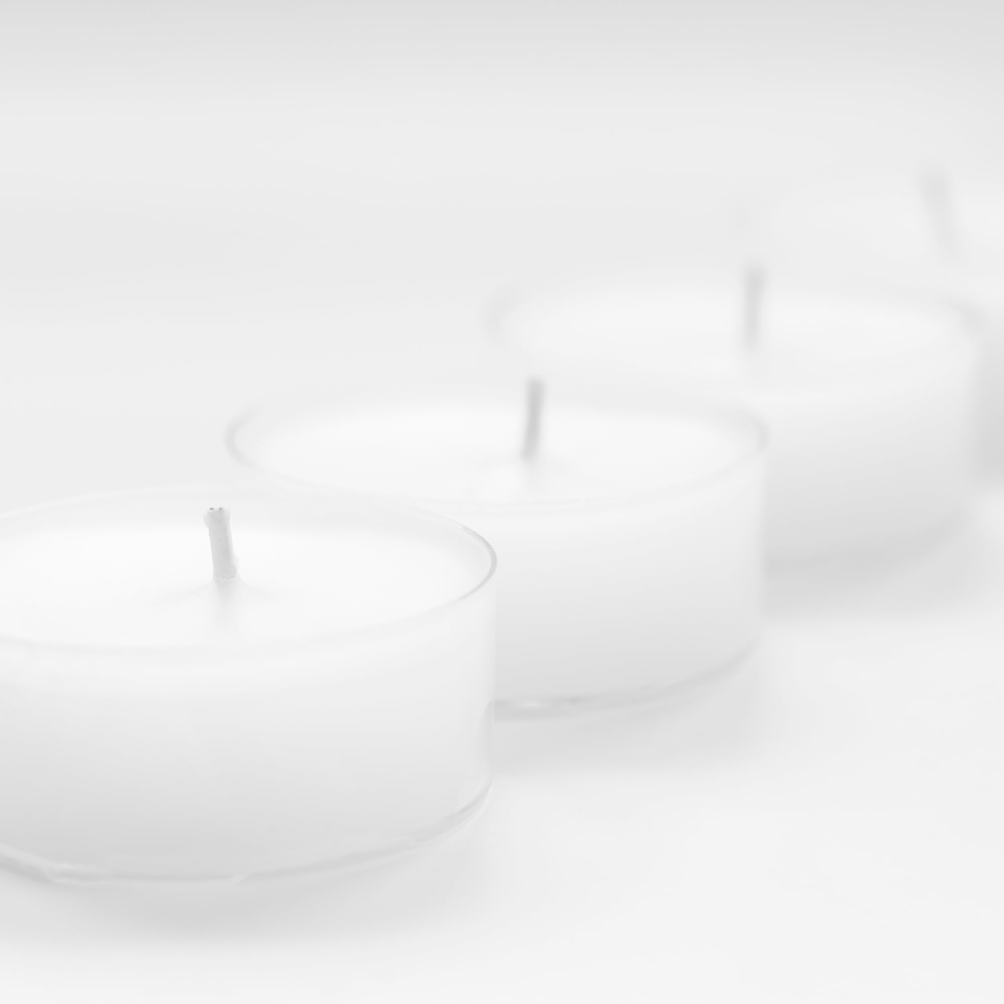 Unscented tea light candles with 1.5 inch diameter and 0.7 inch height in clear cups