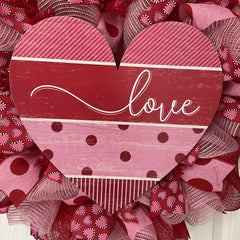 Soft pink fabric deco mesh with polka dot accents and love script on wreath