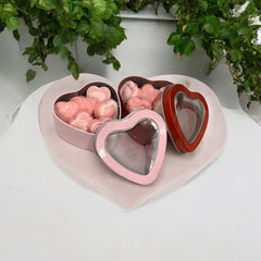 Heart shaped tin with a clear viewing window containing melts