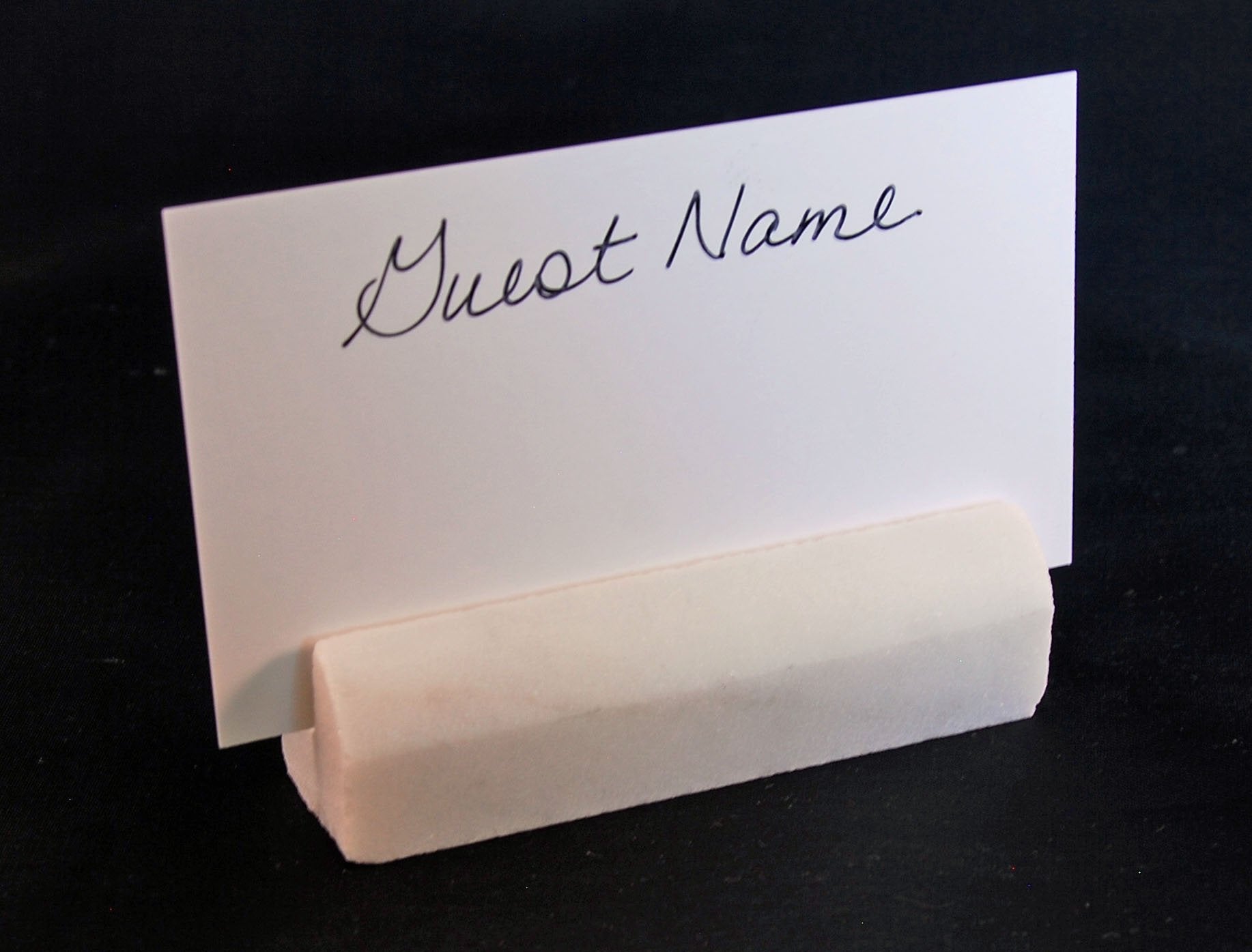 Photo display using Carrara marble place card holders at a wedding or anniversary