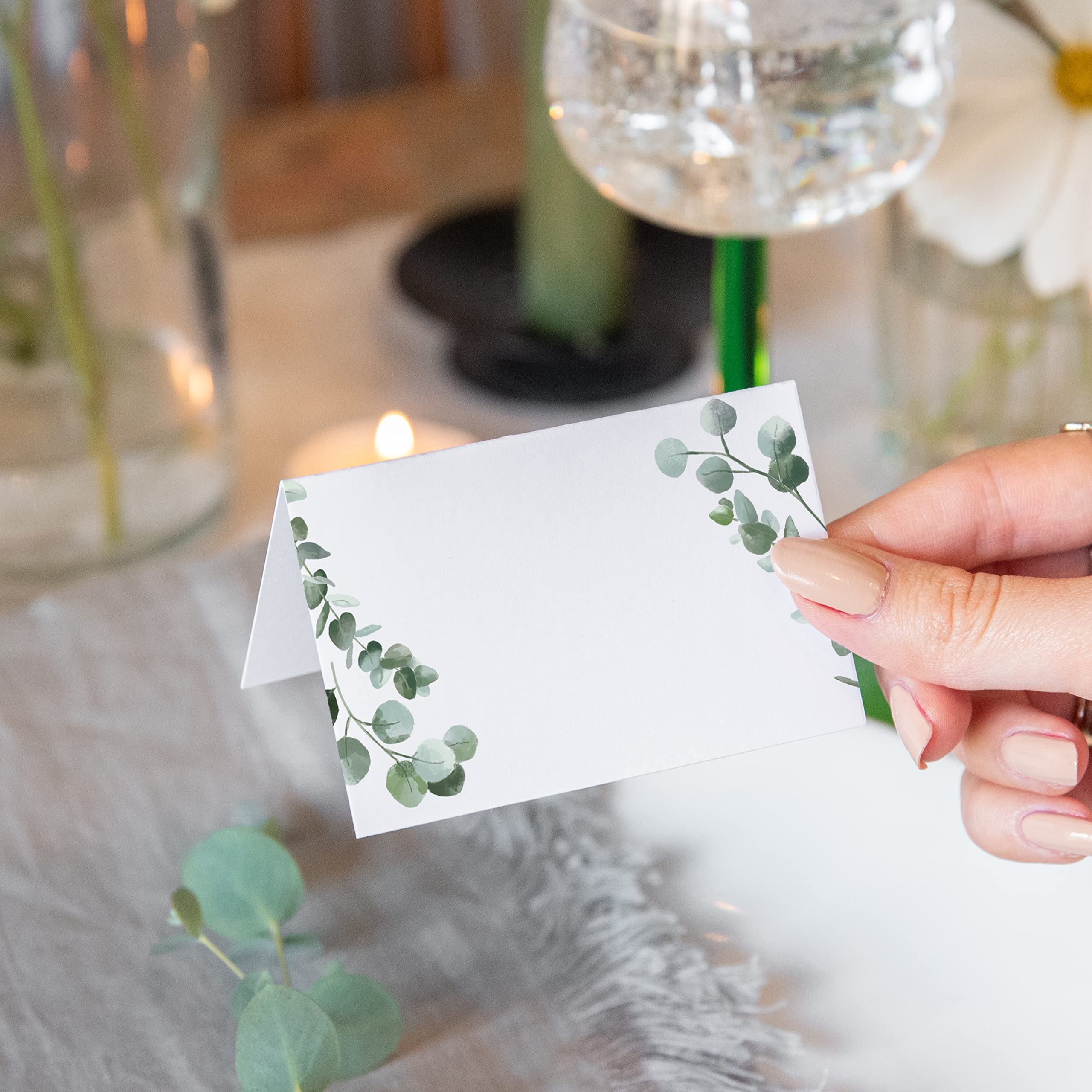White and green folded name cards for table setting