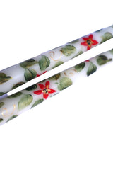 Gold swirl design along a slender taper candle
