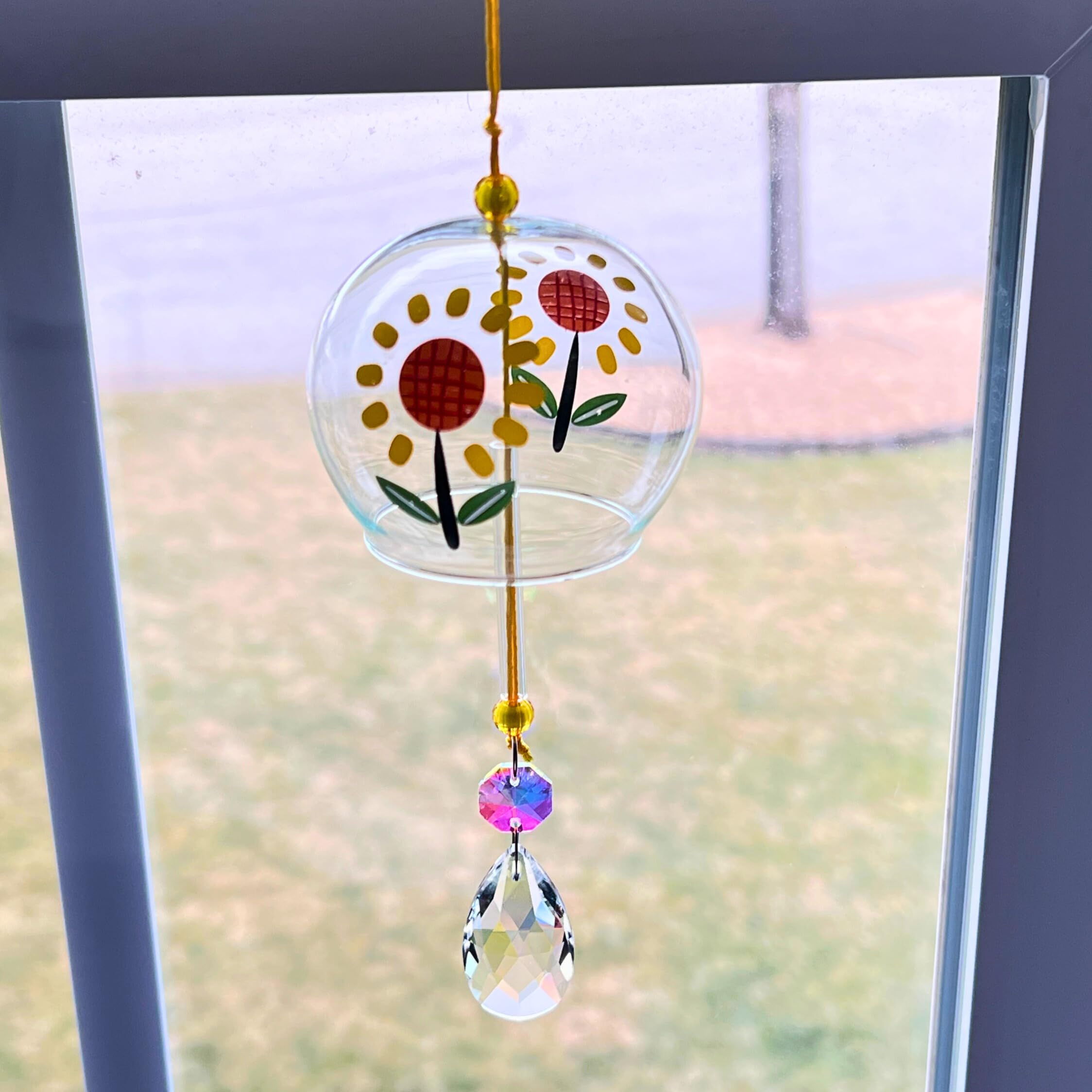 Crystal teardrop pendant on sun catcher window decor