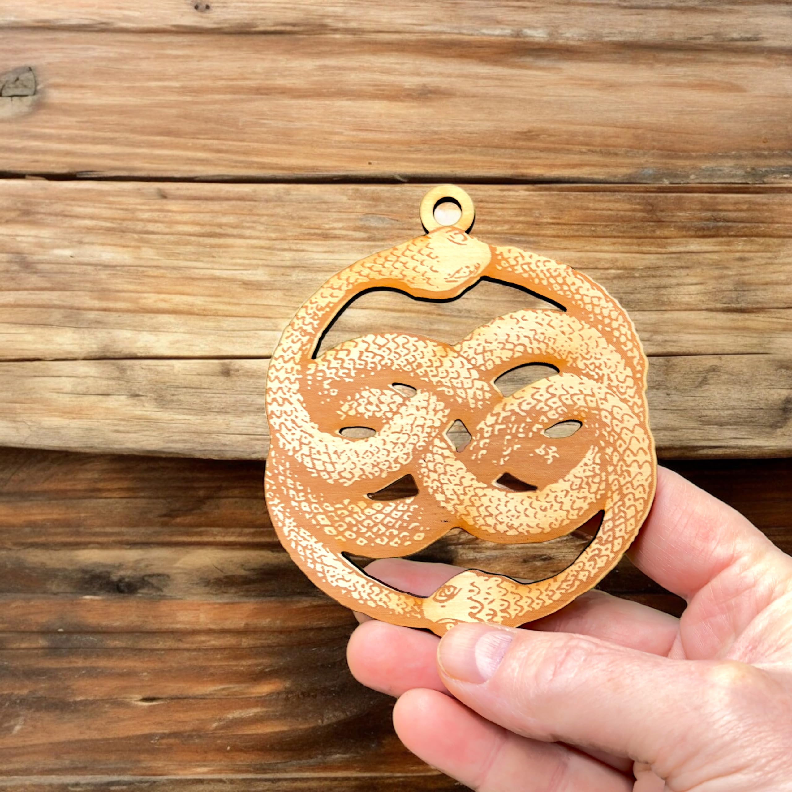 Rustic wooden ornament Ouroboros with natural grain