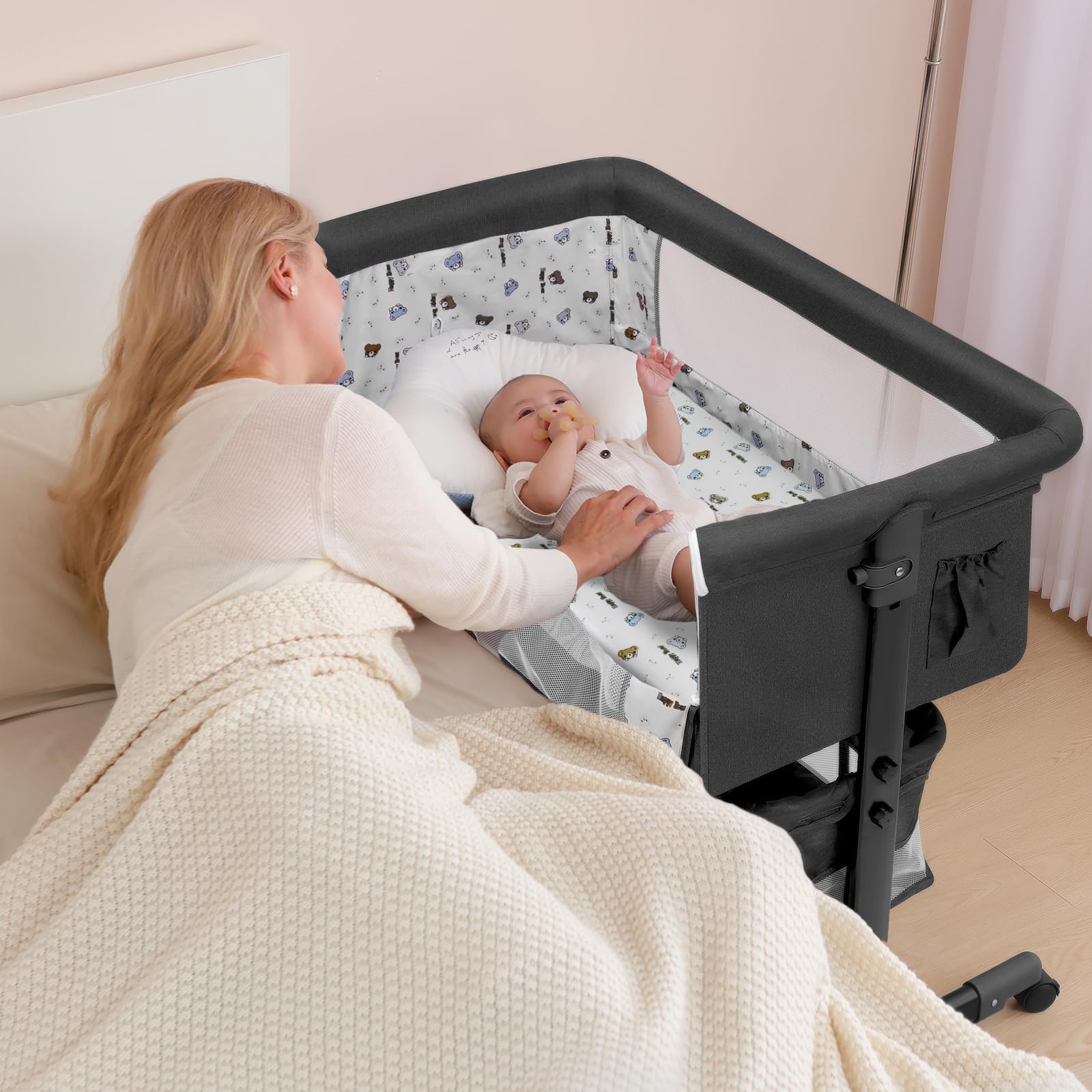 Dark gray bassinet with wheels and storage