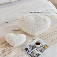 Black heart pillow on bed decor setup