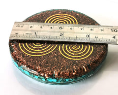 Triskelion symbol on turquoise coaster with resin finish